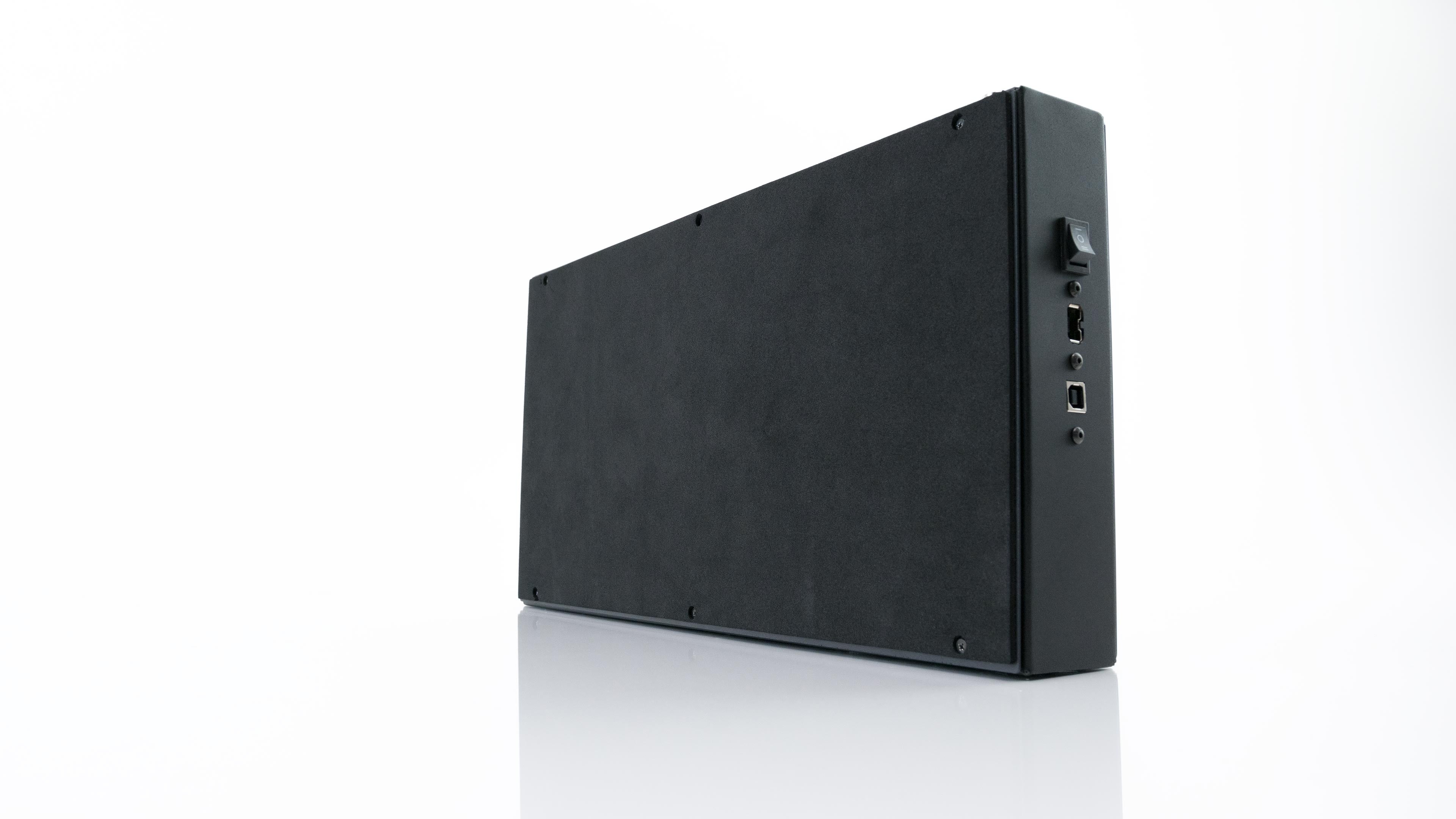 Rear and underside view of the Hit Box Cross|Up showing its full no-slip bottom, profile switch, and connection ports.